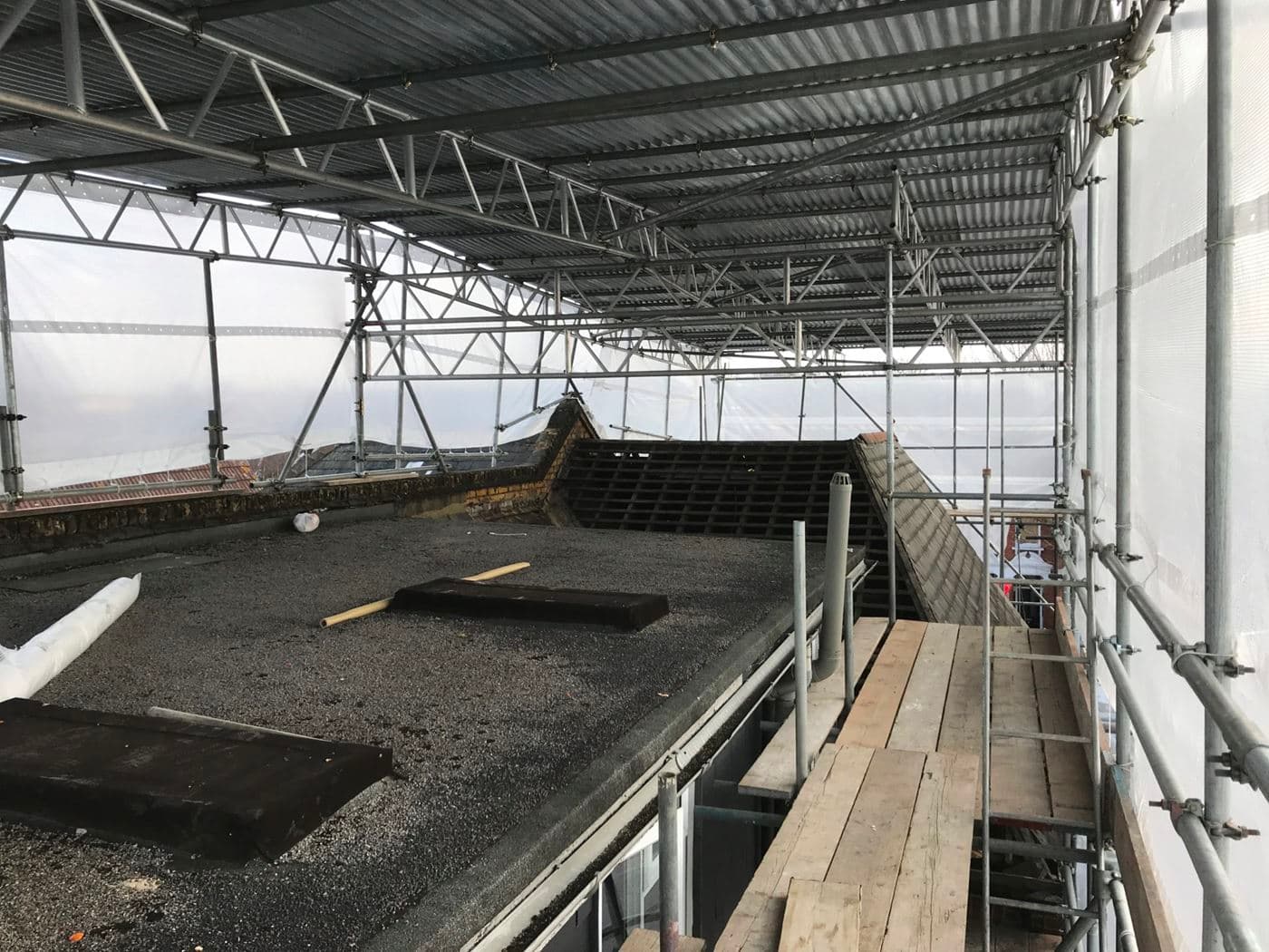 A Scaffolding on top of a roof being repaired