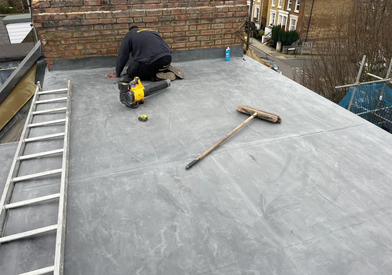 Roofer finishing an EPDM flat roof in London