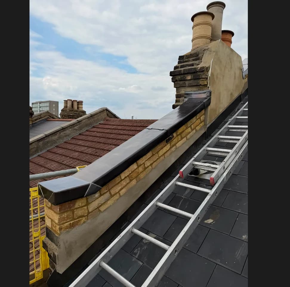 Lead parapet capping fitted beside a slate roof