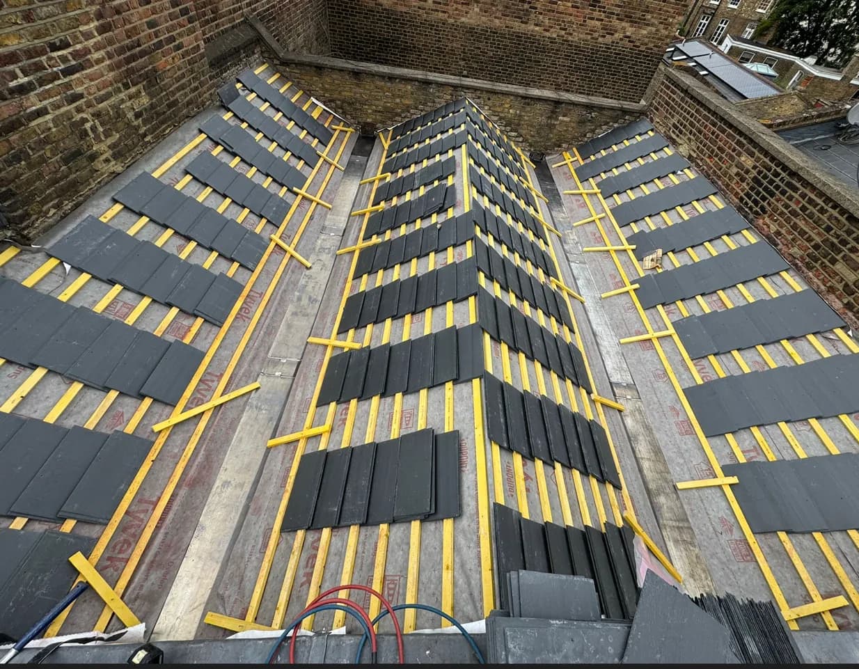 A N.H.R.B.S. roofer working high on a London roof